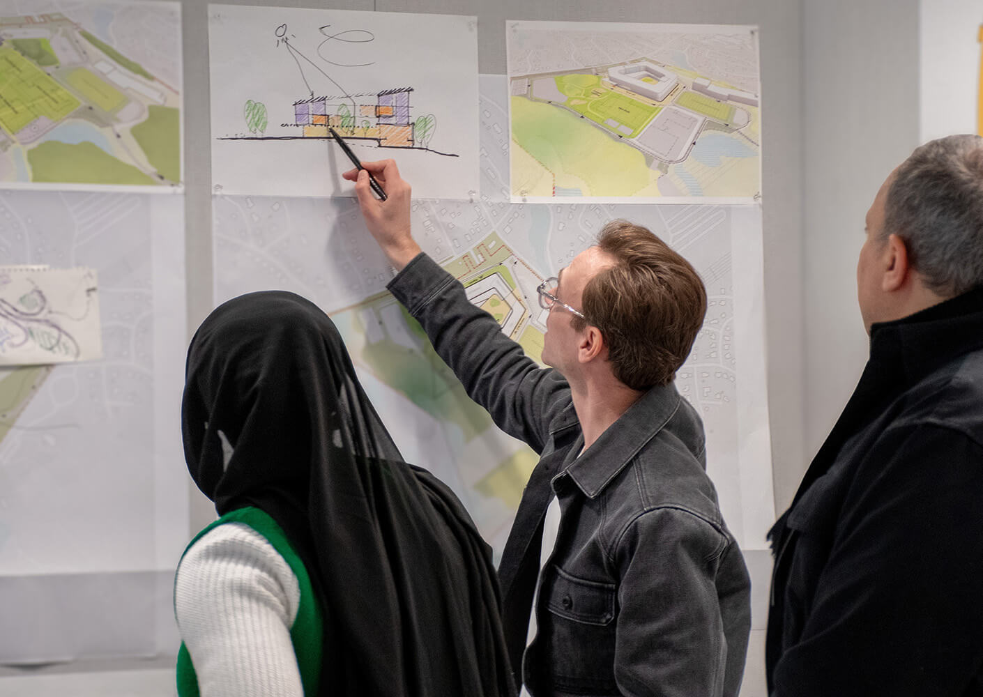 Team discussing architectural sketches during a design review session.