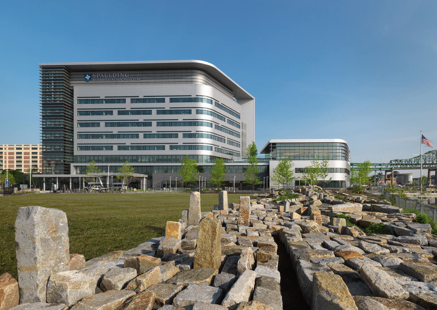 Spaulding Rehabilitation Hospital surrounded by landscaped stones and grass.