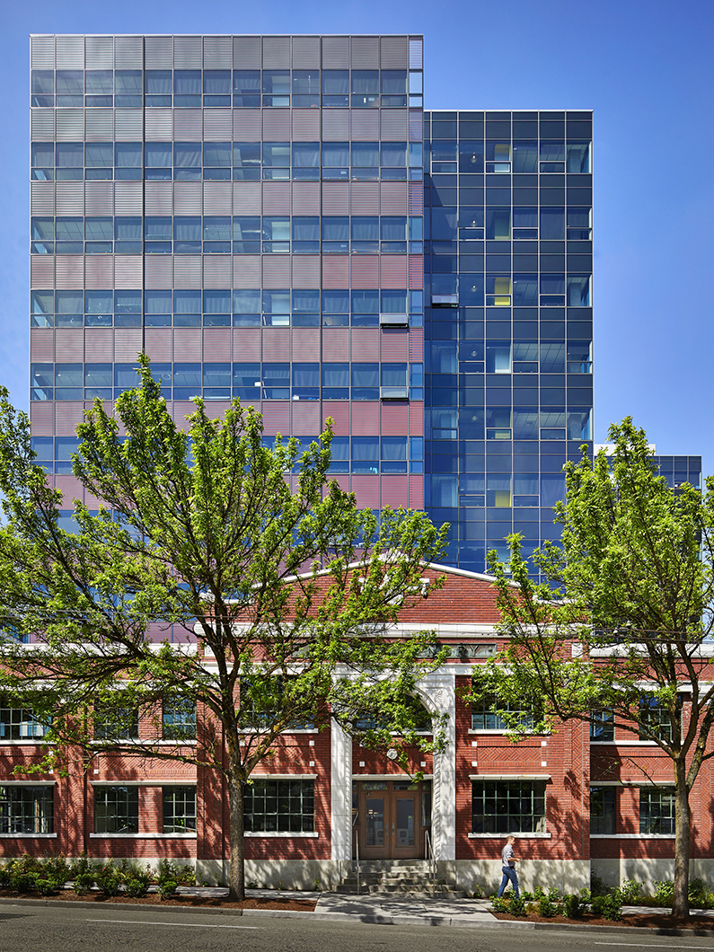 Exterior view of historic brick Troy Laundry building with modern glass tower above