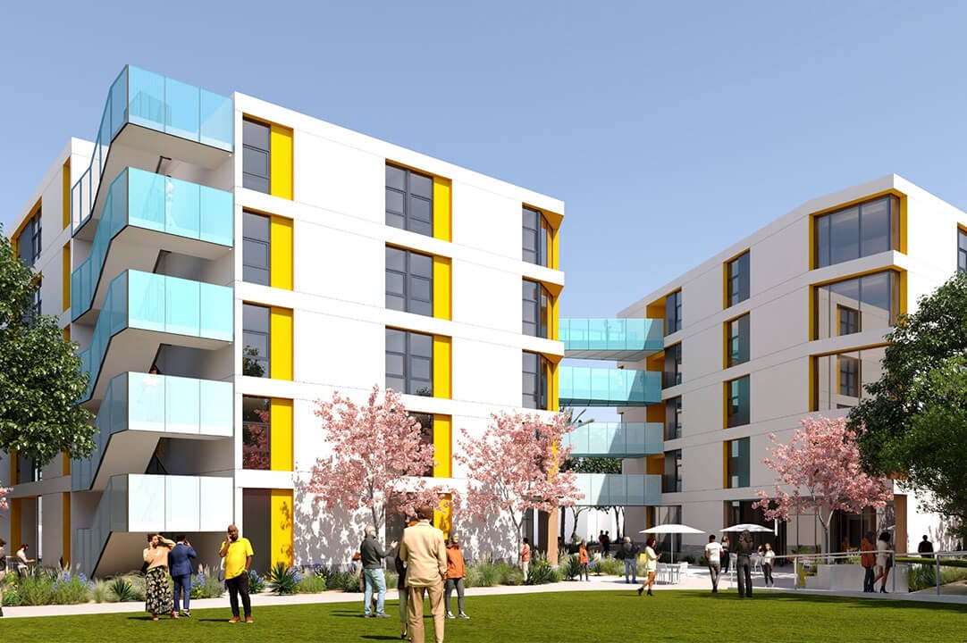 Modern apartment complex with colorful balconies and people enjoying the garden area.