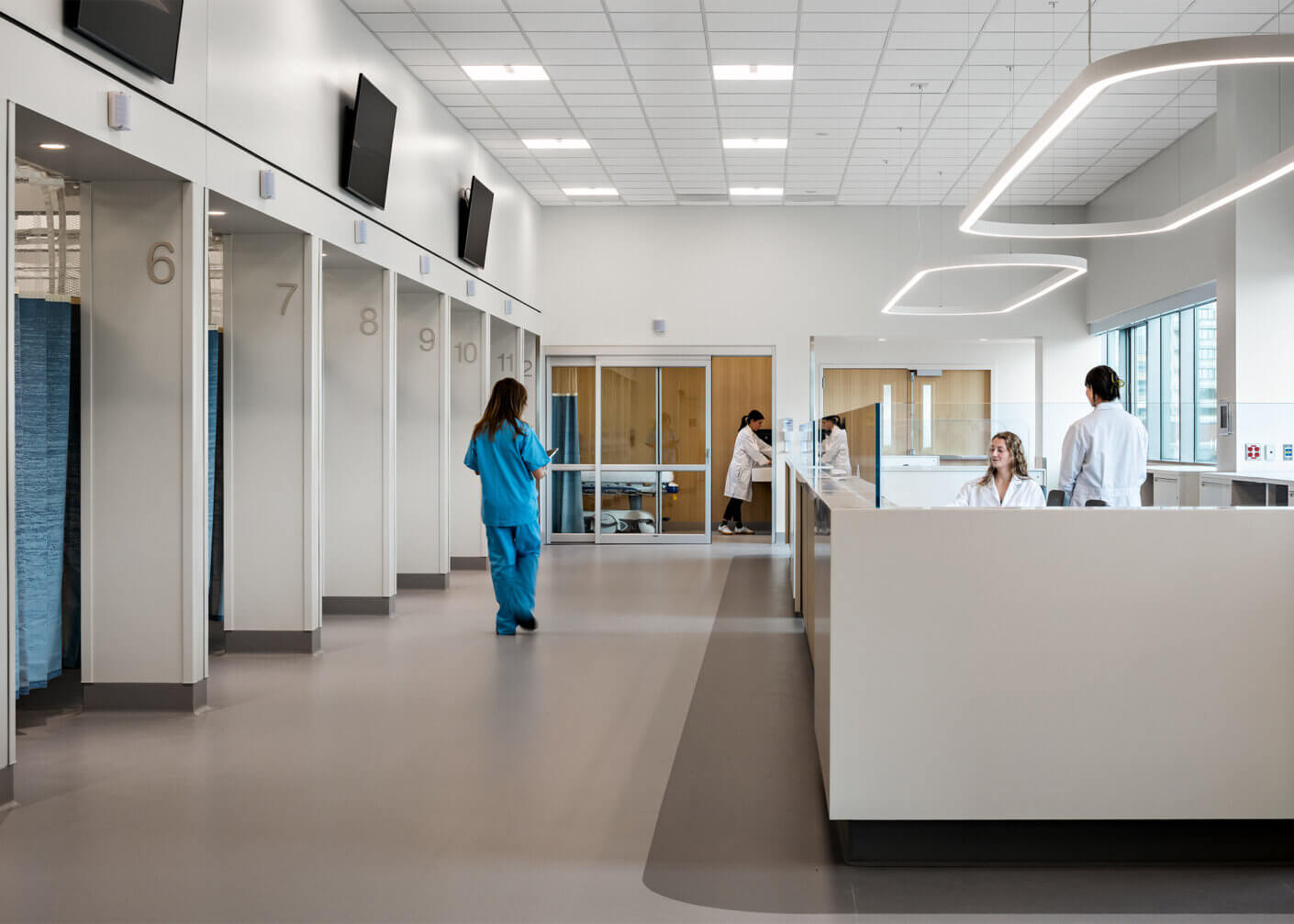 Modern hospital interior with medical staff and numbered patient rooms.