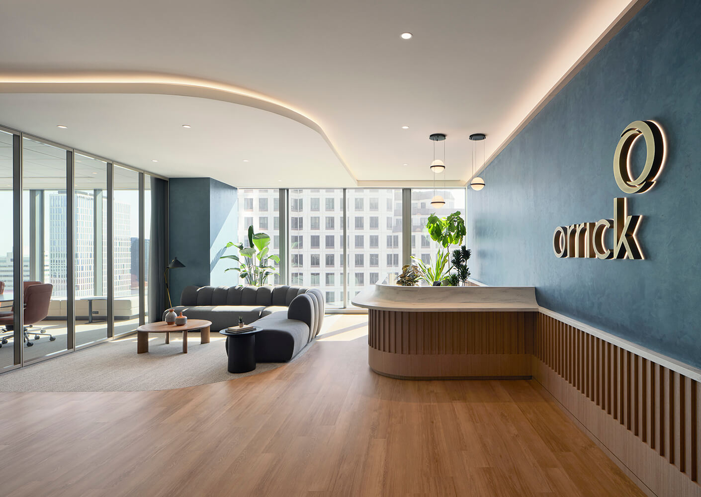 Modern law office lobby with stylish seating, wooden floors, and a large window view, featuring plants and contemporary lighting.