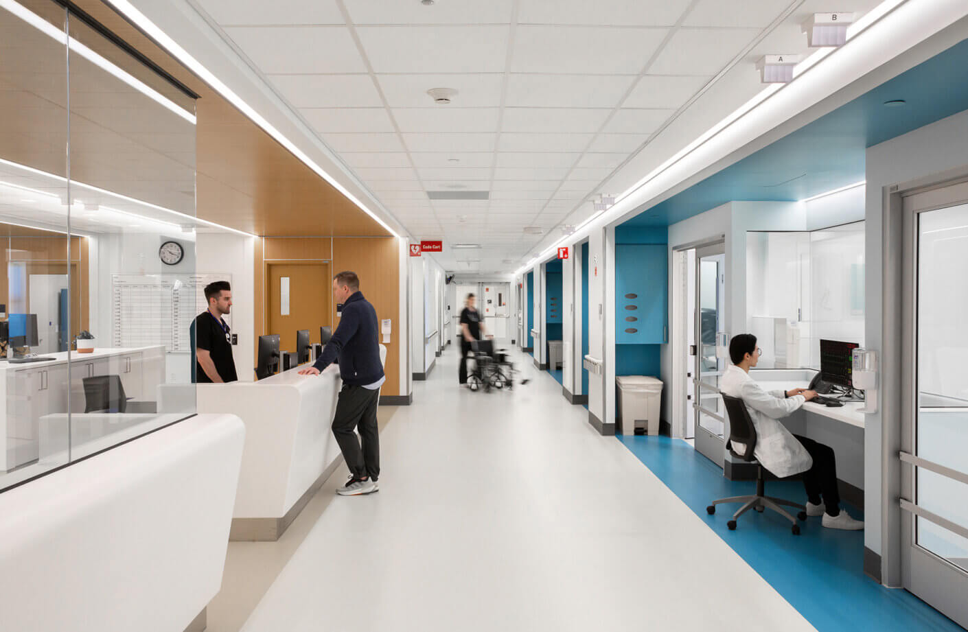 Hospital unit with people in corridor