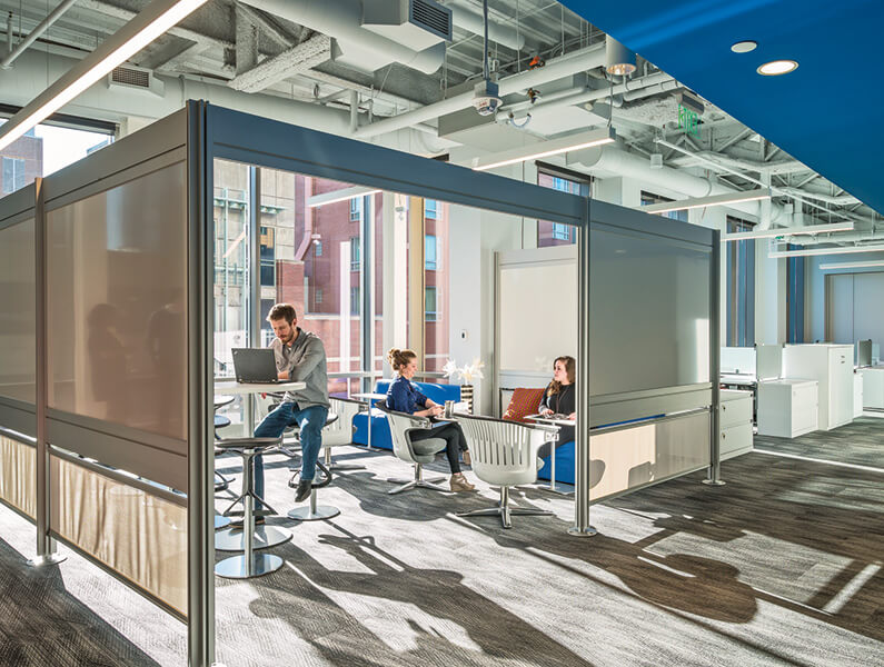 open office meeting area with people collaborating