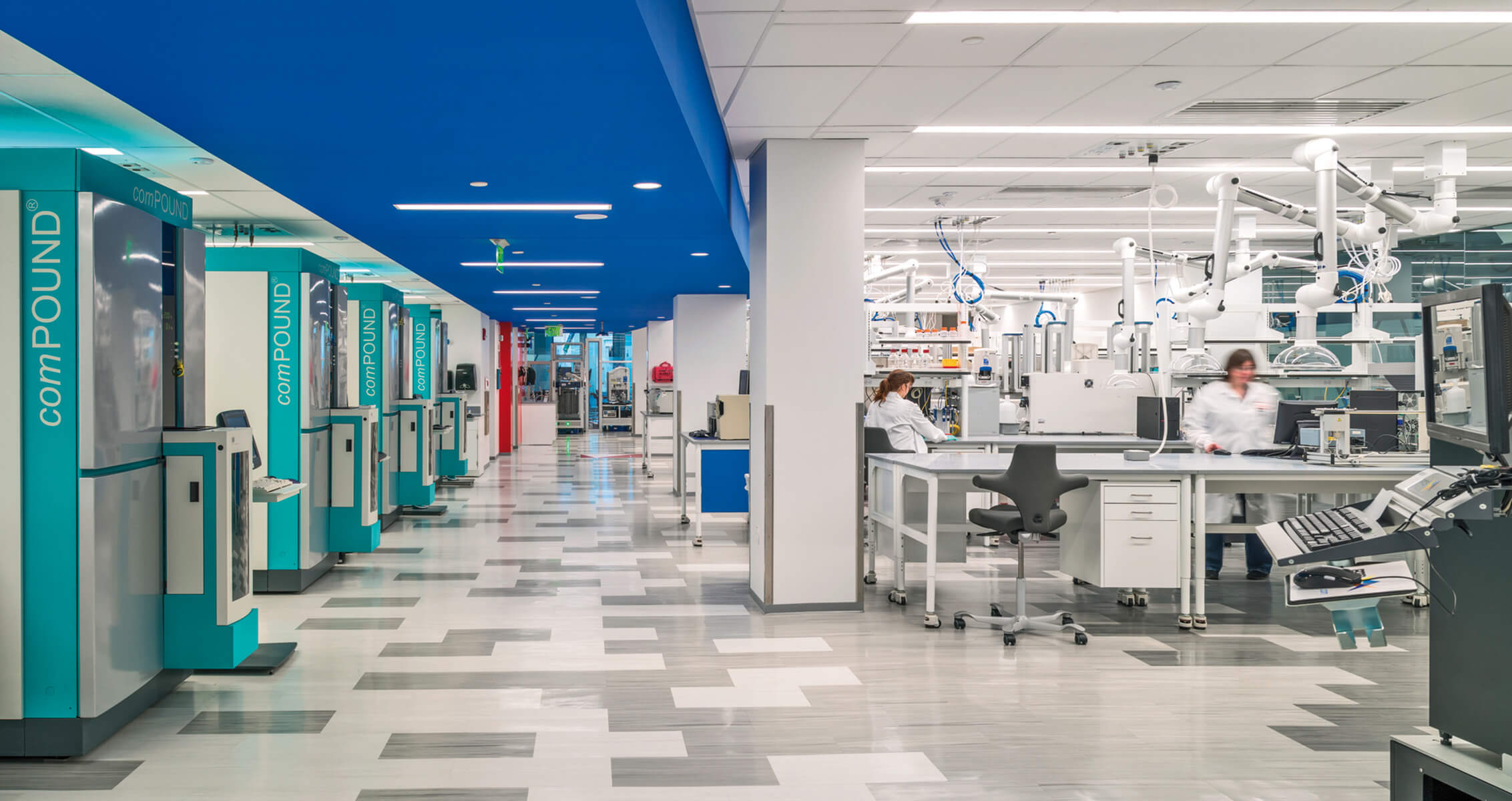 large open automation lab with benches and people working