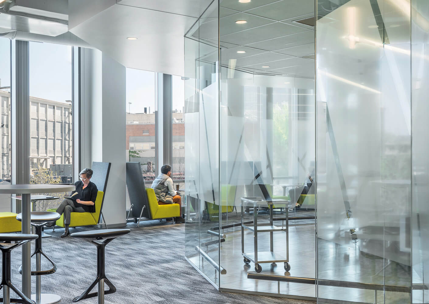 people working in an office space with windows and glass to automation labs