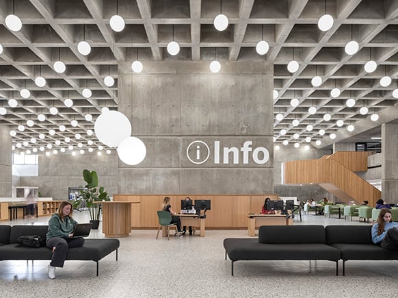Modern public information lobby with seating and glowing lights.