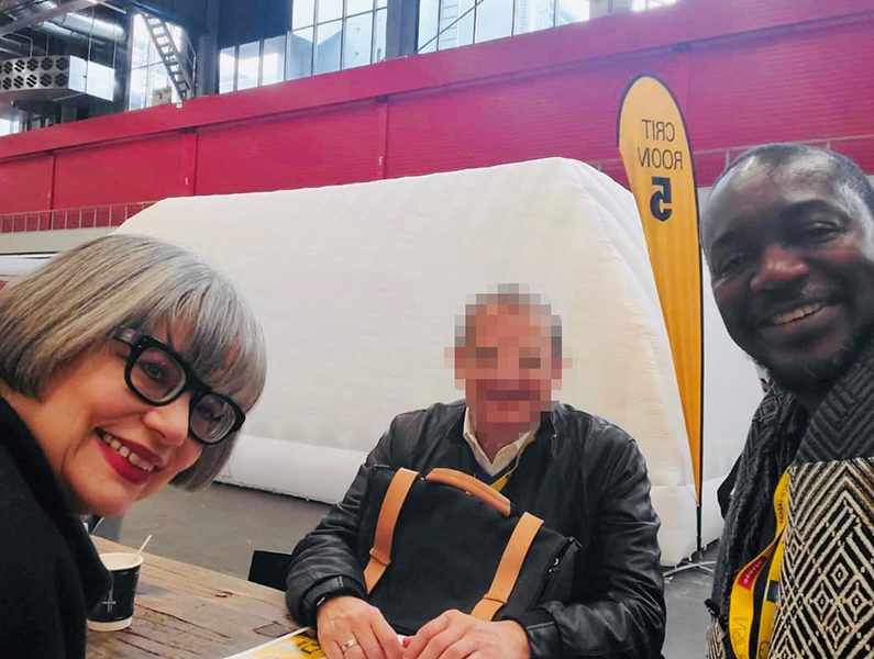 Pat Bosch, left, and Cecil Abbey, right, at the World Architecture Festival in Amsterdam, 2019. (Note: The face of the individual at center has been obscured to protect personal privacy.)