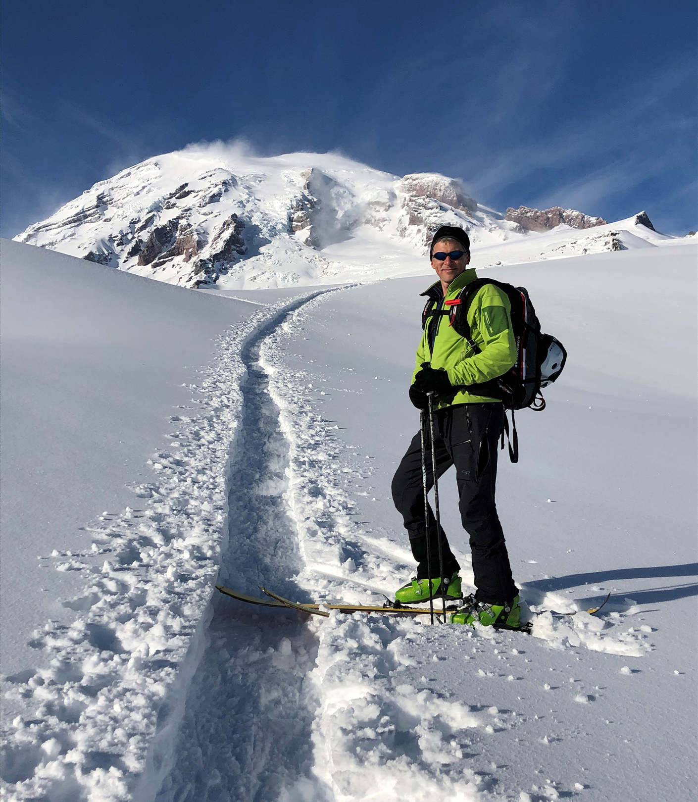 Ed climbing up Mount Rainier with skis