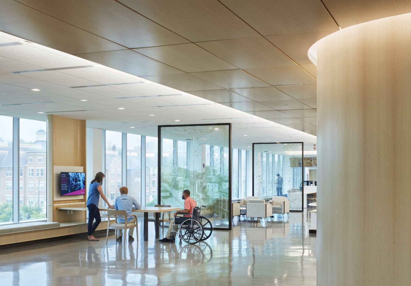 University of Cincinnati Gardner Neurological Institute. Main lobby that contains multi use areas for learning and waiting, museum, café, and classrooms. The spaces are divided by glass panels that contain artwork of the local culture of Cincinnati.