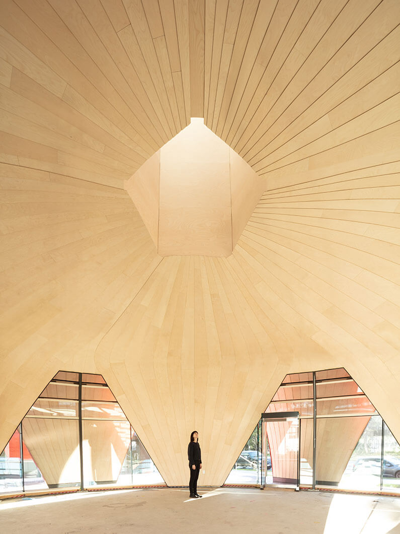 Photo of pavilion interior showing wood walls and oculus.