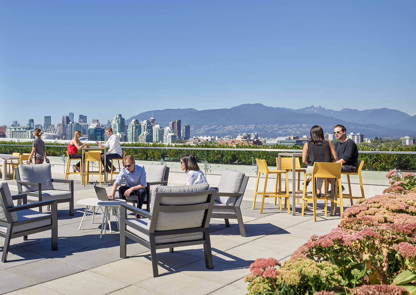 View of rooftop amenity with expansive views of the city and North Shore mountains.