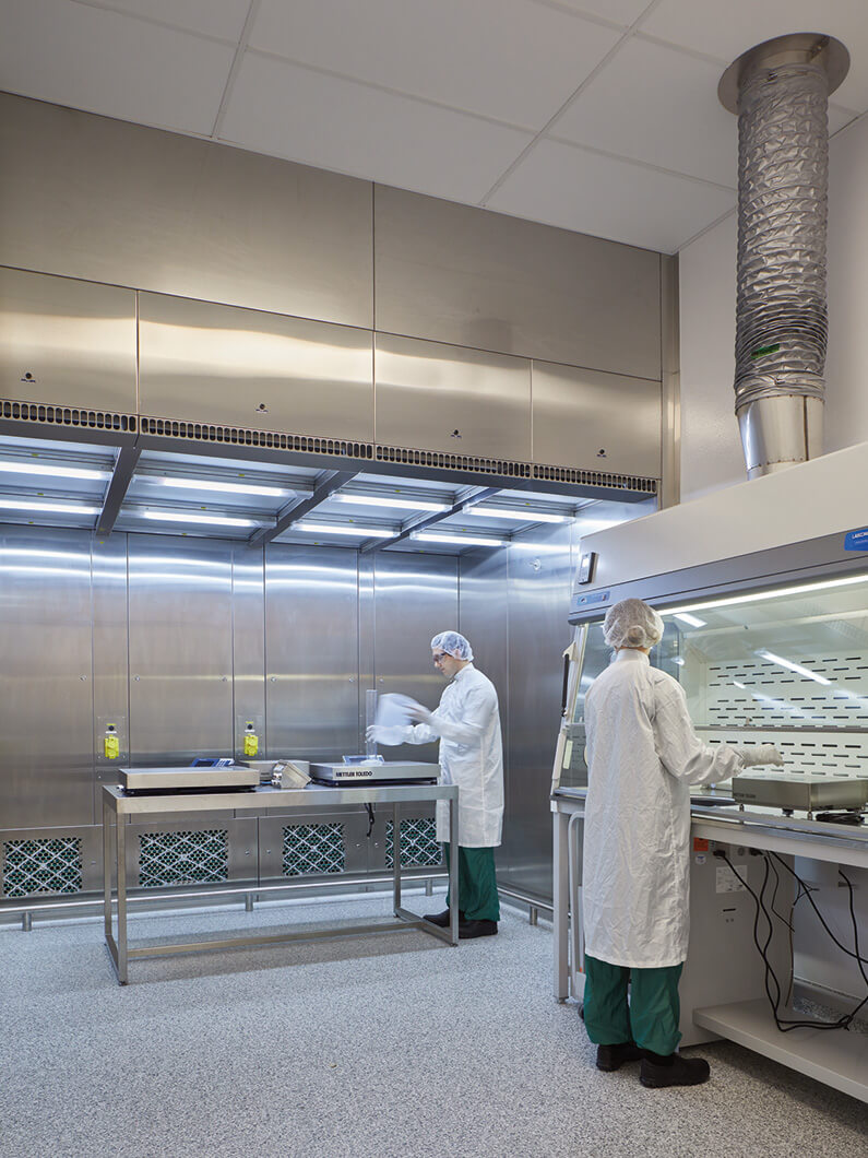 cGMP lab with people working in full PPE