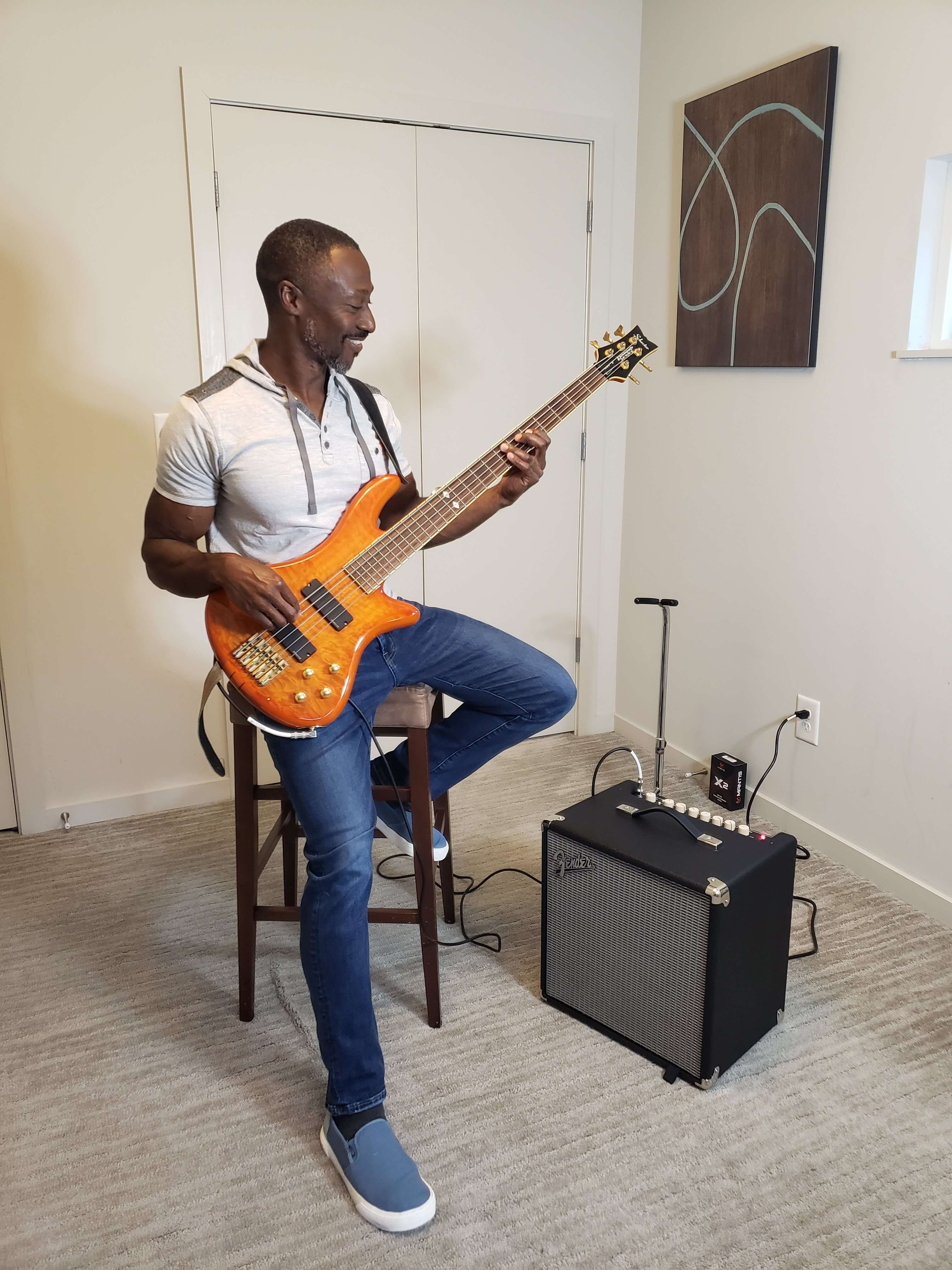 Godfrey Gaisie plays the bass at home