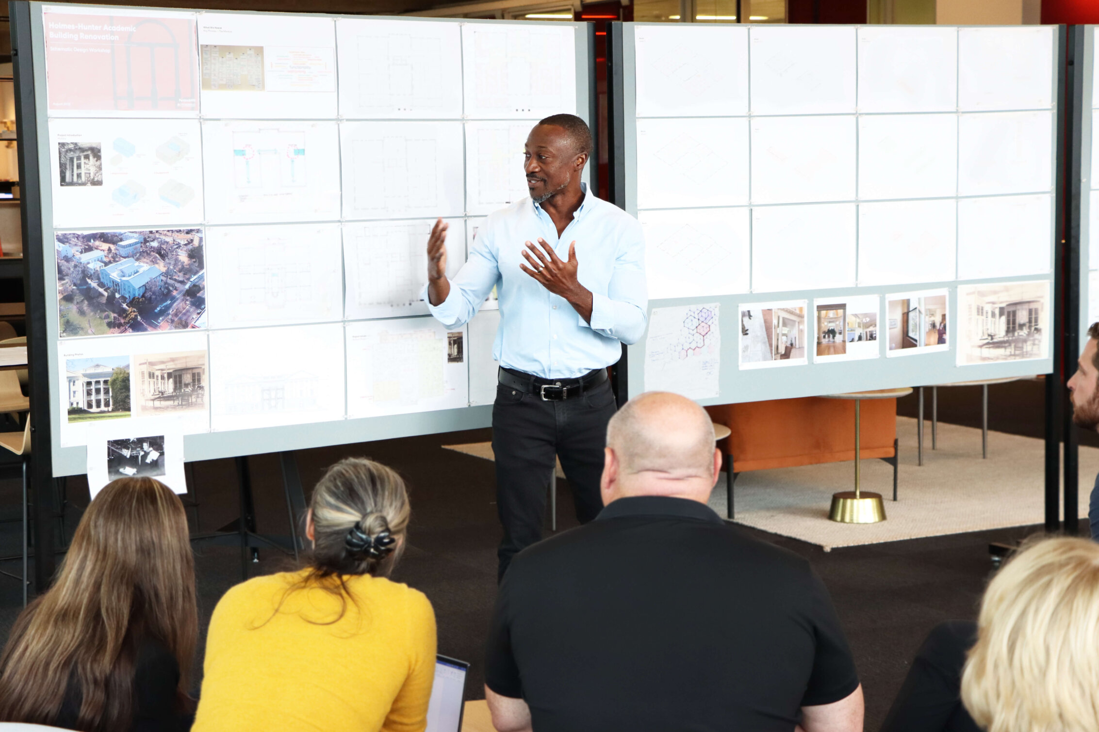 Godfrey Gaisie presents an ongoing project in front of a pinup wall for an Atlanta studio weekly Design Forum