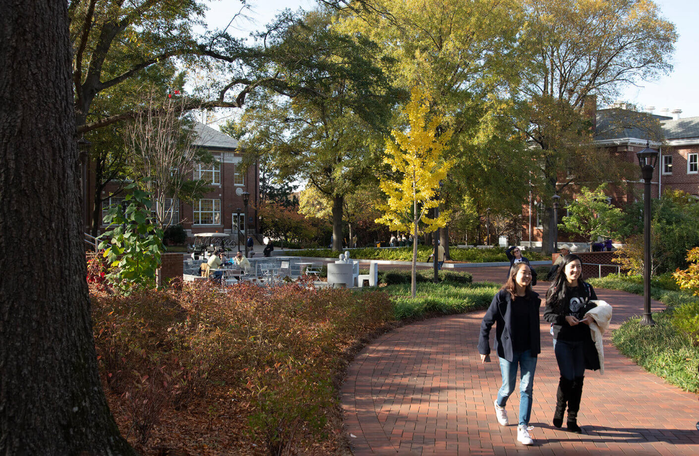 Georgia Tech students walking along the brick path through Harrison Square