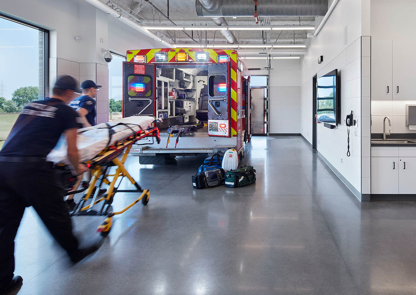 Photo of students conducting a medical simulation in an ambulance bay in a healthcare education building