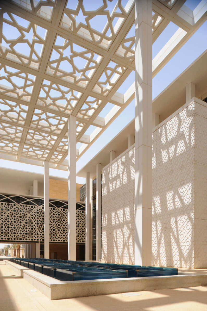A light-filled courtyard with a wide, geometric awning.