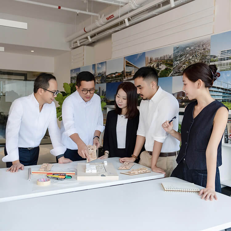 Team collaborating on design concepts in a modern office workspace.