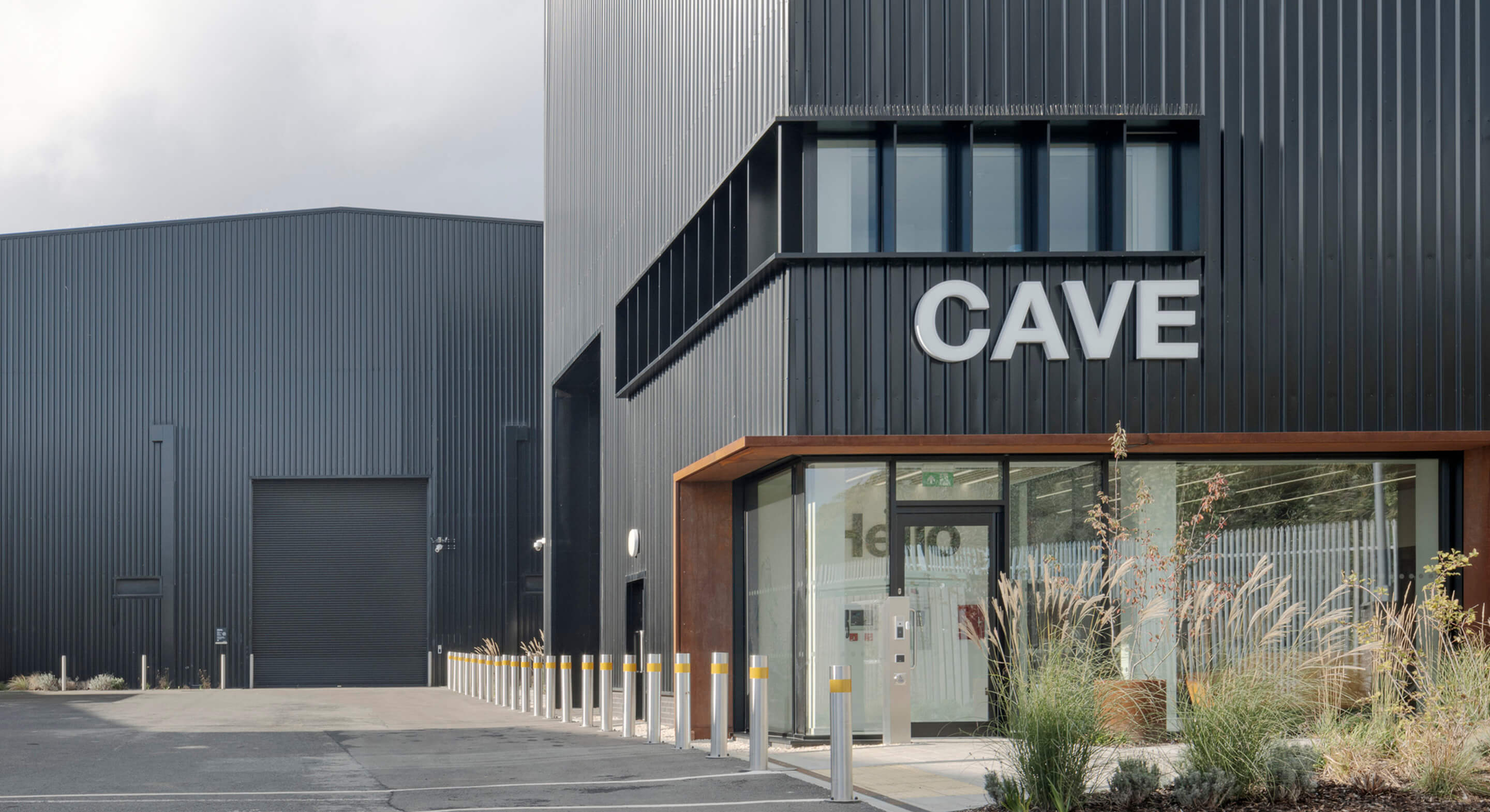 Black exterior of building with the words Cave on it.