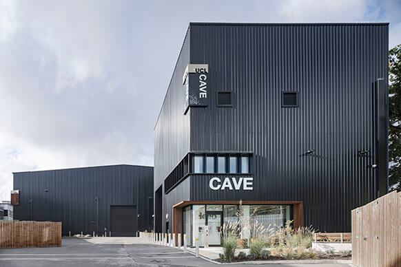Black exterior of building with the words Cave on it.