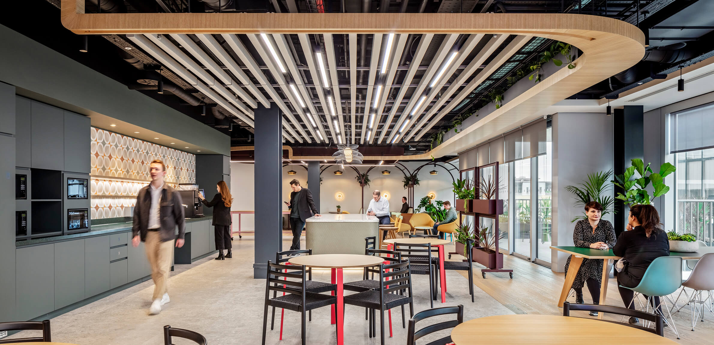 People socializing and eating in an office cafe.