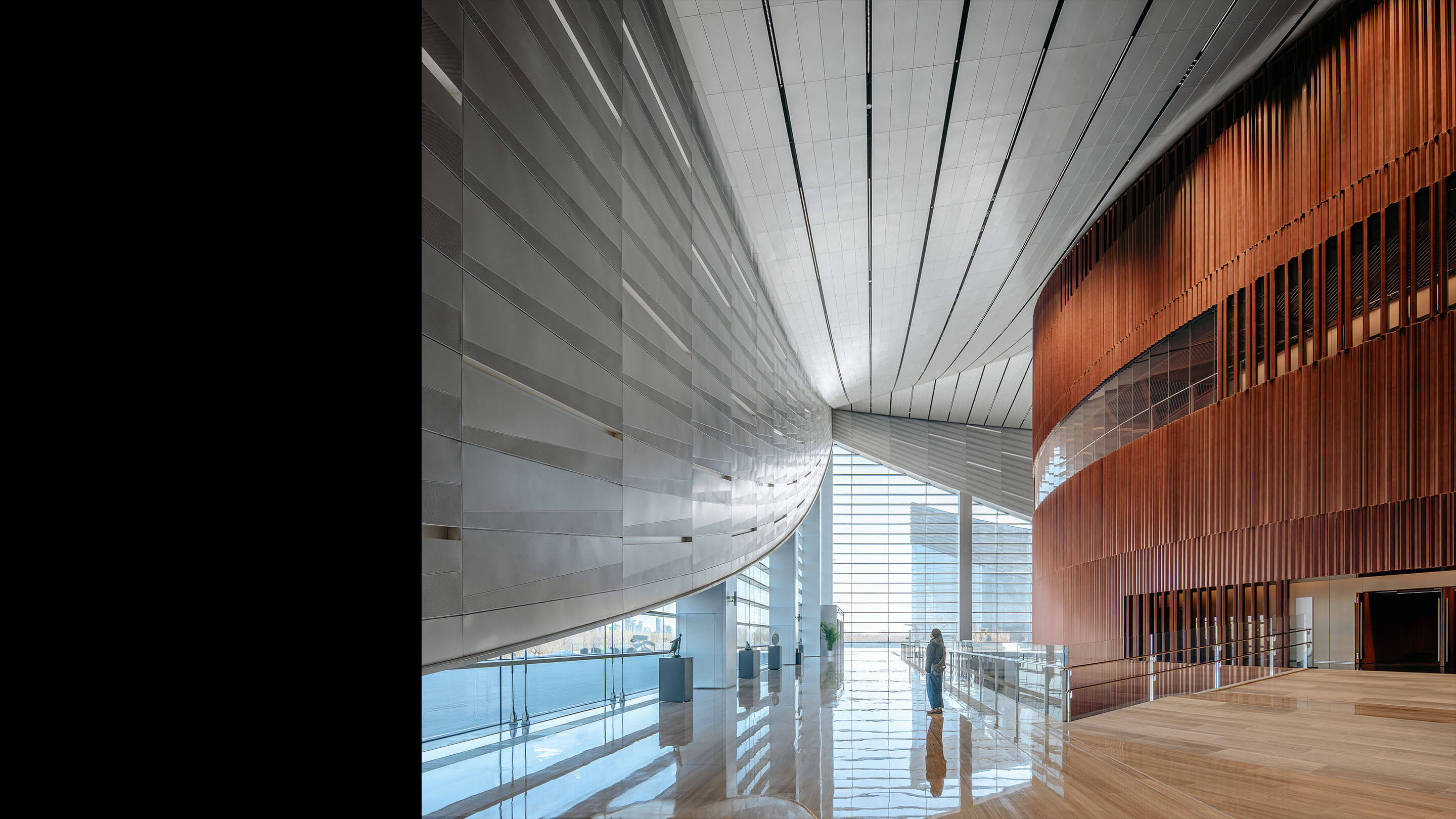 Lobby featuring pleated metal panels and large floor to ceiling windows