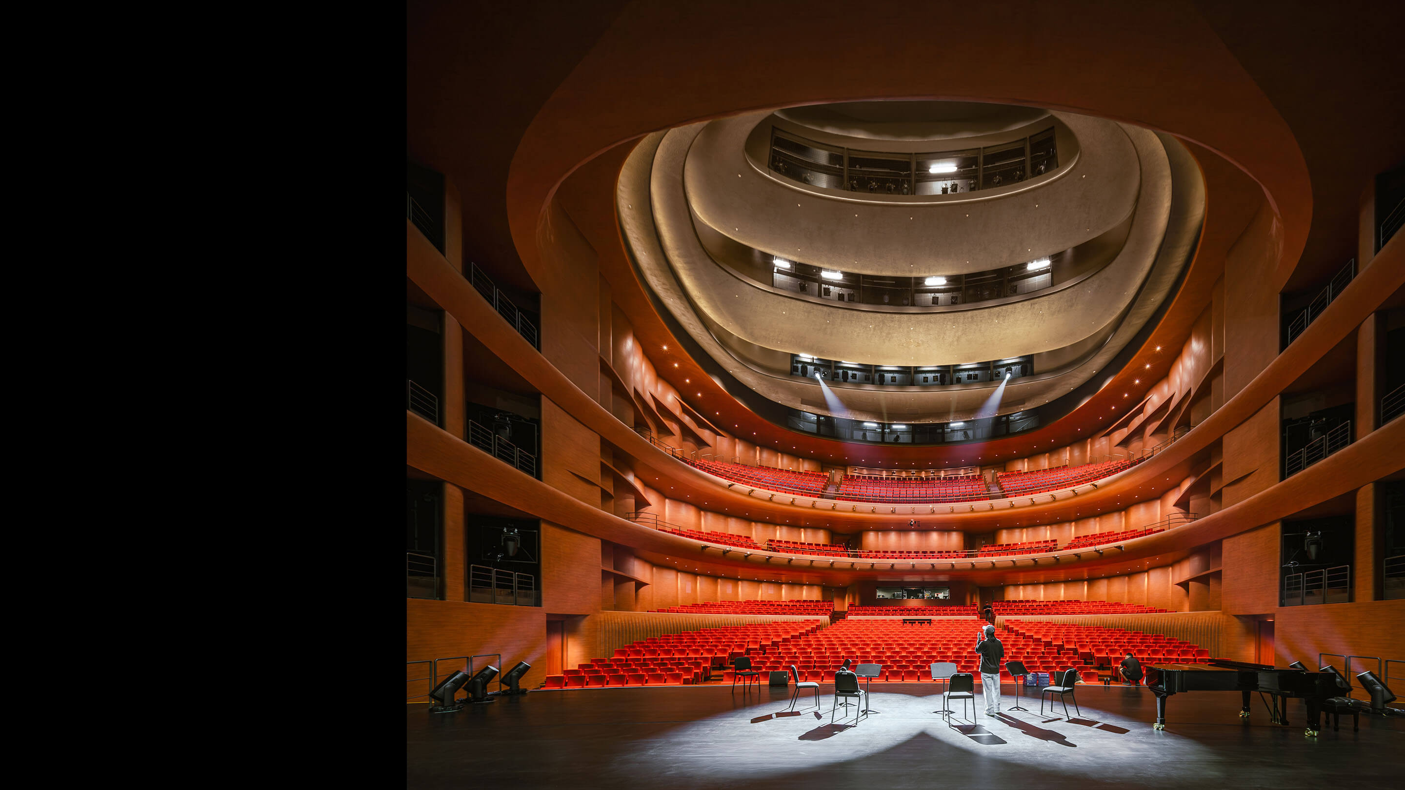 Opera house interior, person on stage looking out towards seats