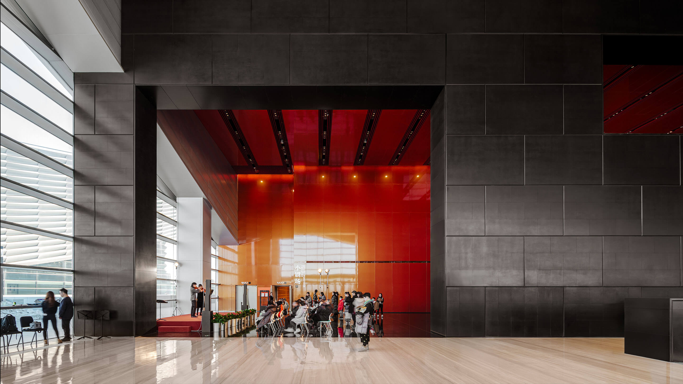 Group of people enjoying concert in lobby performance space