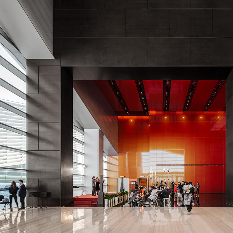 Group of people enjoying concert in lobby performance space