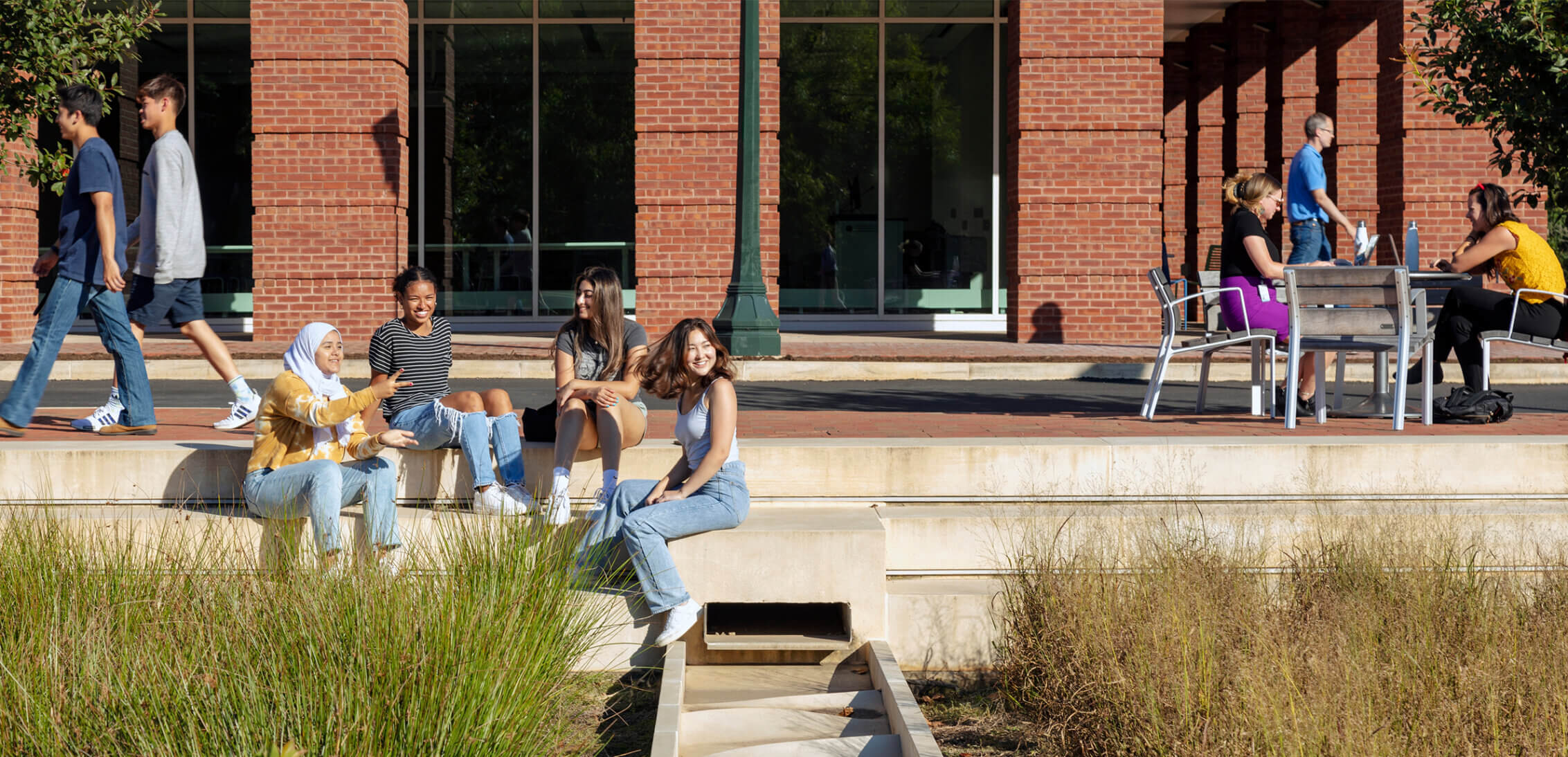 Students sitting among the landscape at the University of Virginia.