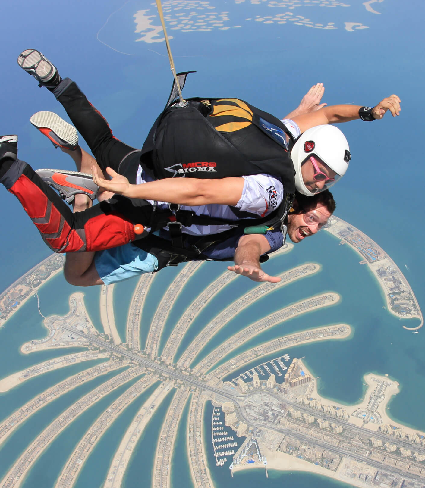 two skydivers over the ocean