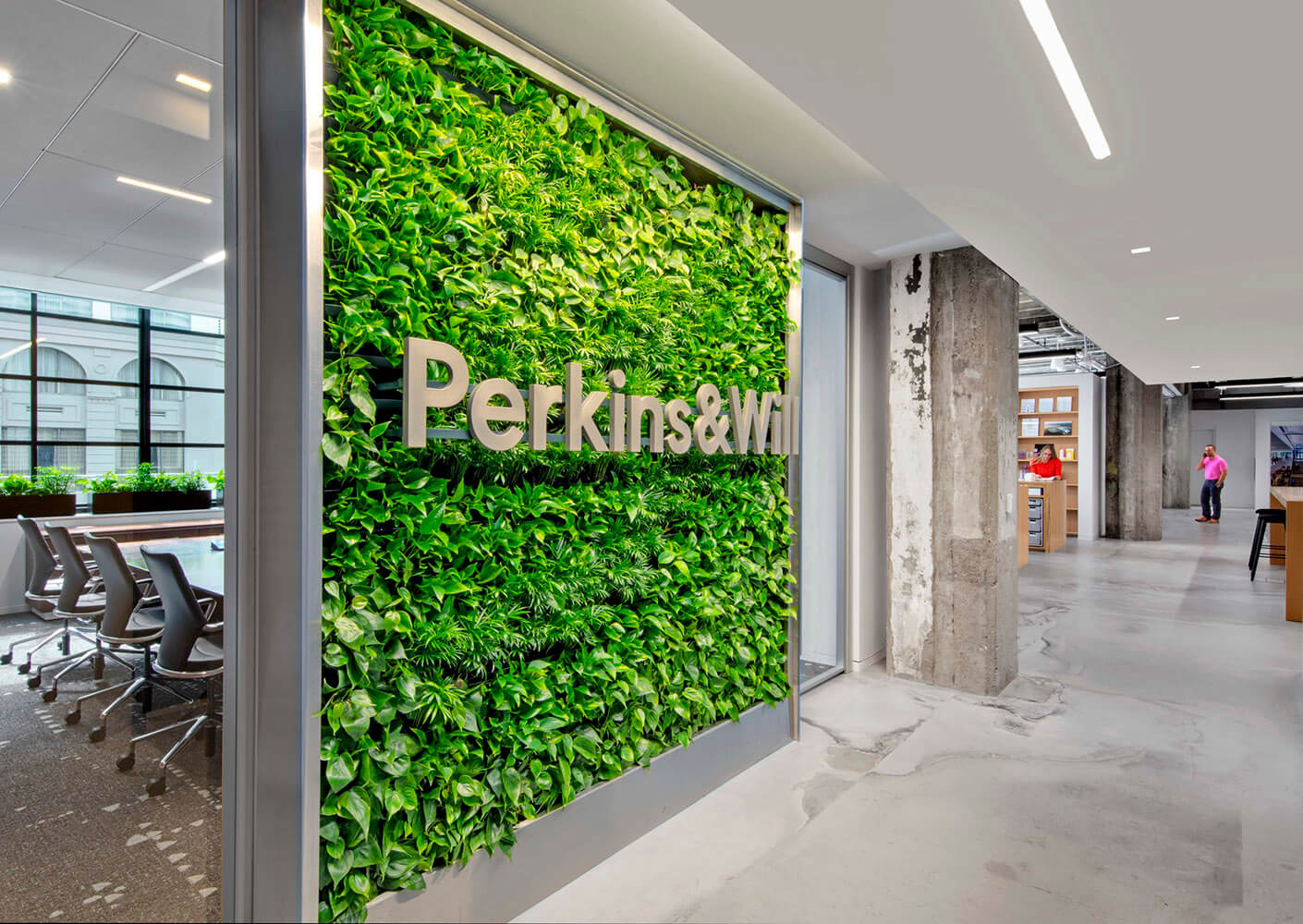 A green, living wall with the Perkins&Will logo