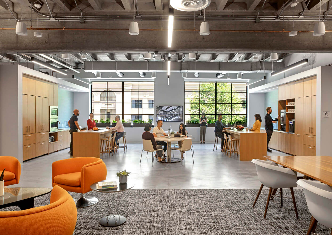 a studio space with orange chairs and two garage doors