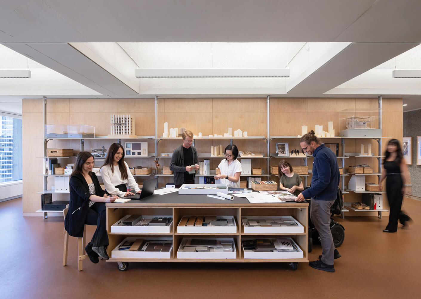 A material library in an architecture studio with people working