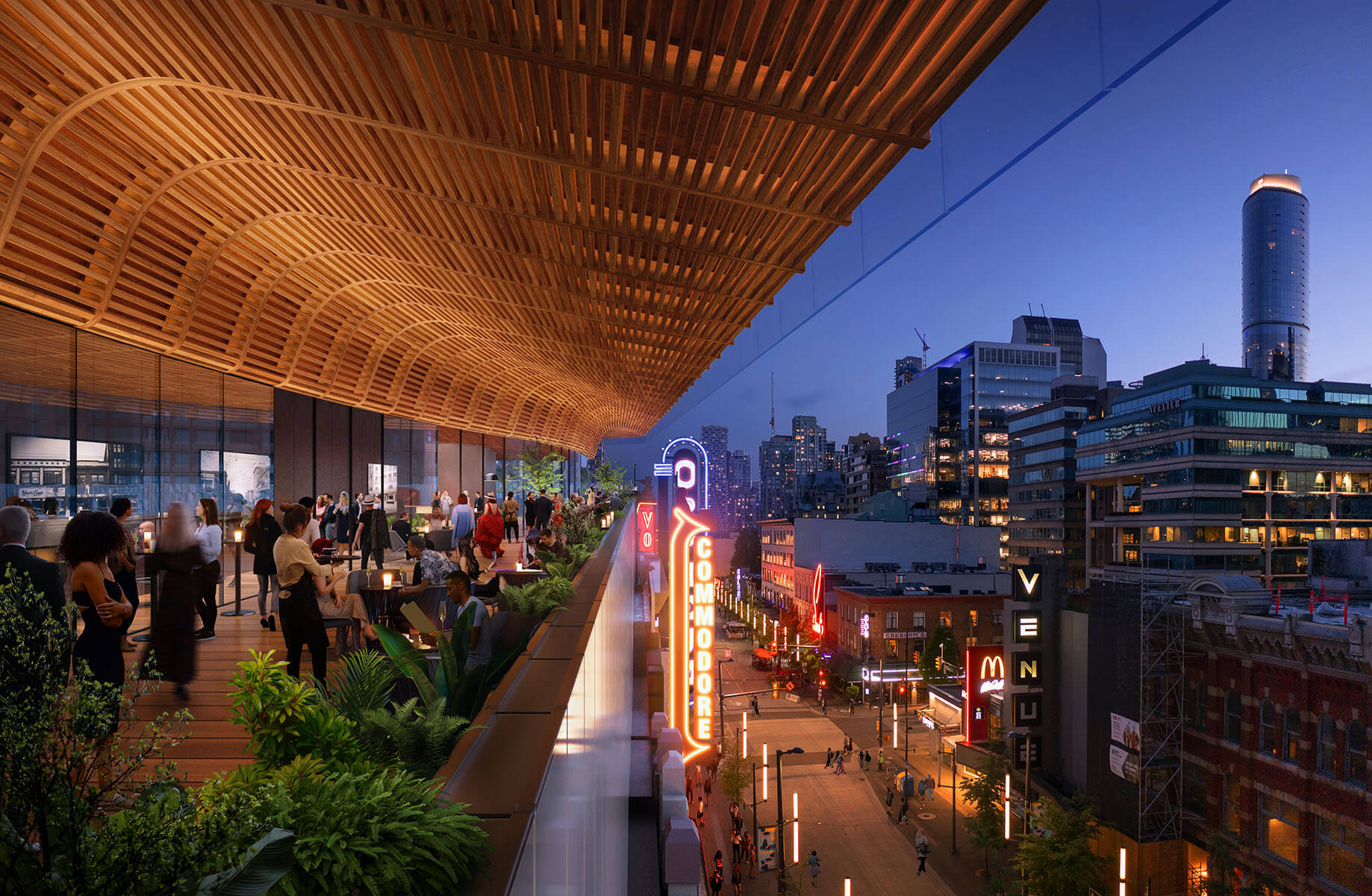 A nighttime shot of an outdoor balcony overlooking a city