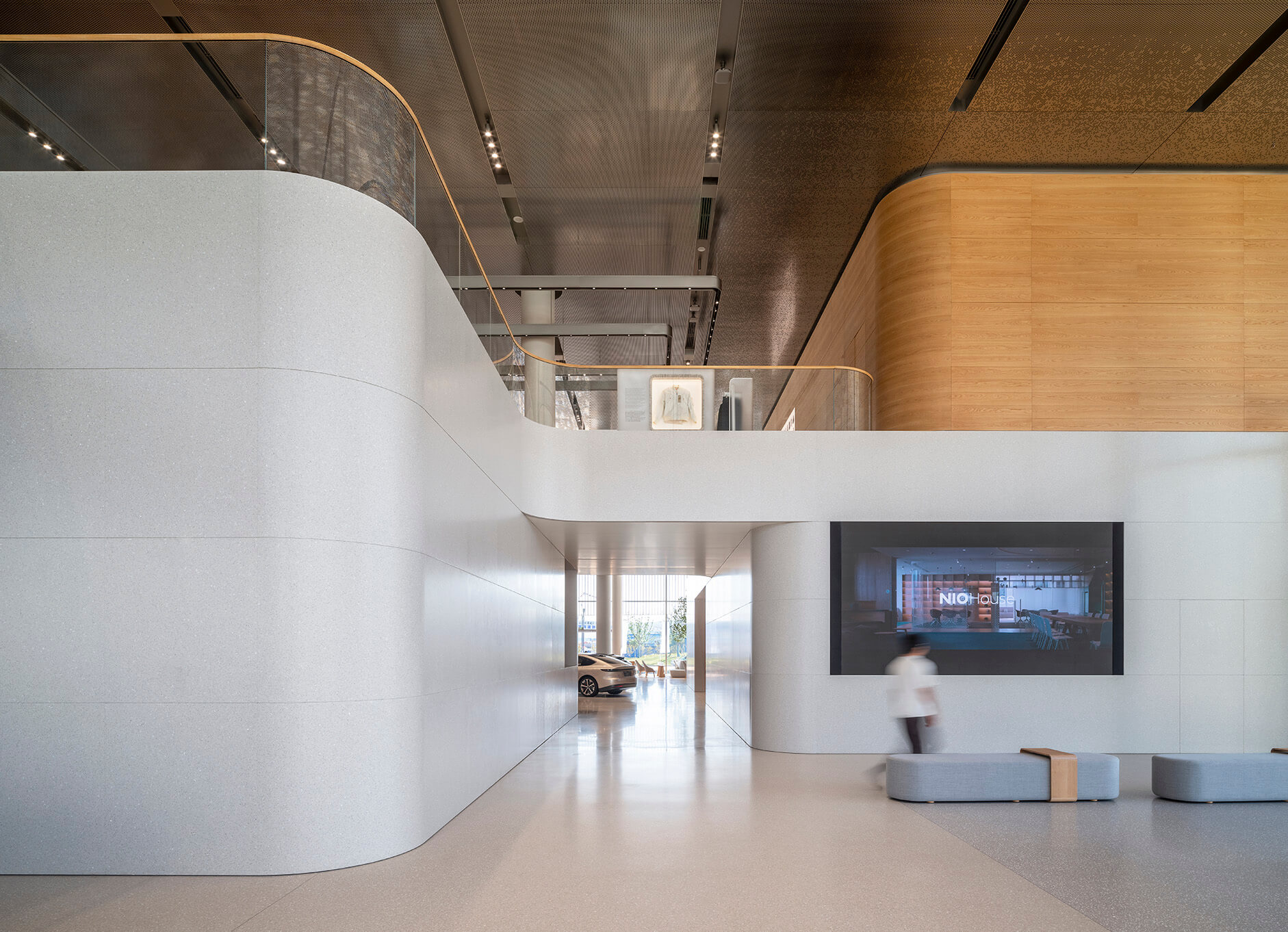 A hallway and seating area in an electric vehicle showroom