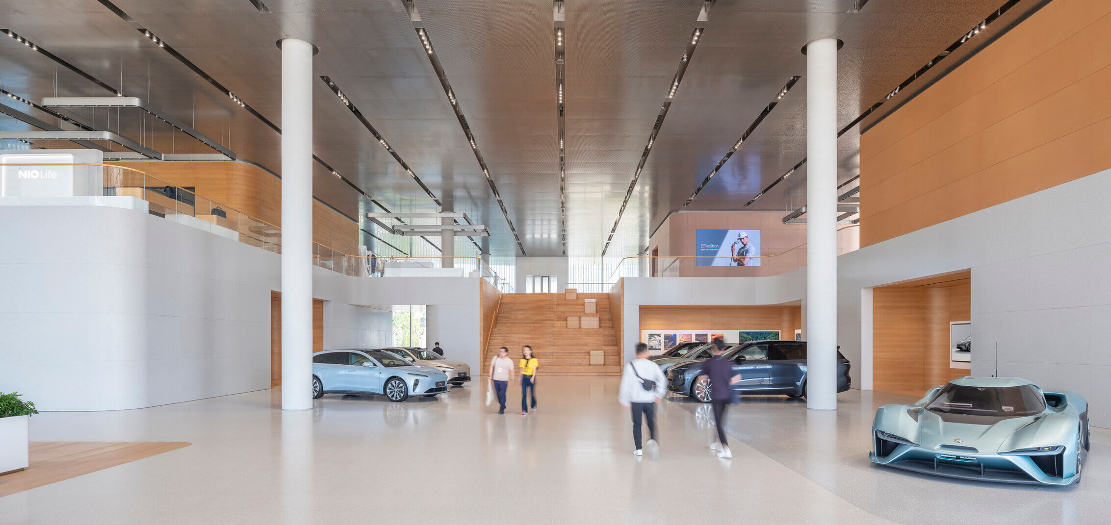 People within the interior of an electric vehicle showroom