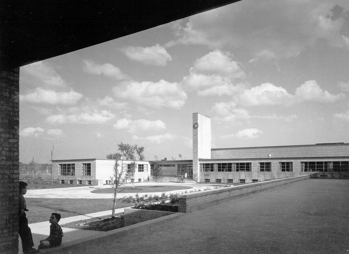 Children in the foreground of a school courtyard