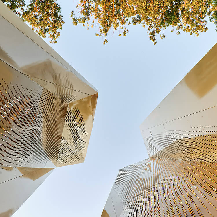 An abstract view of a perforated metal sculpture.