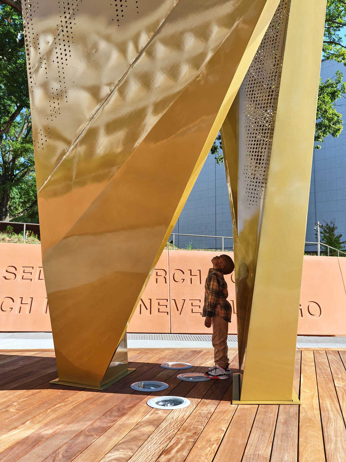 A boy looking up at the becon sculpture from within.