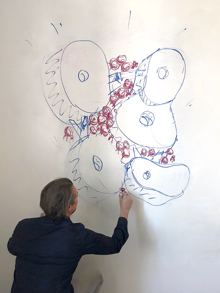 Person sketching at a whiteboard