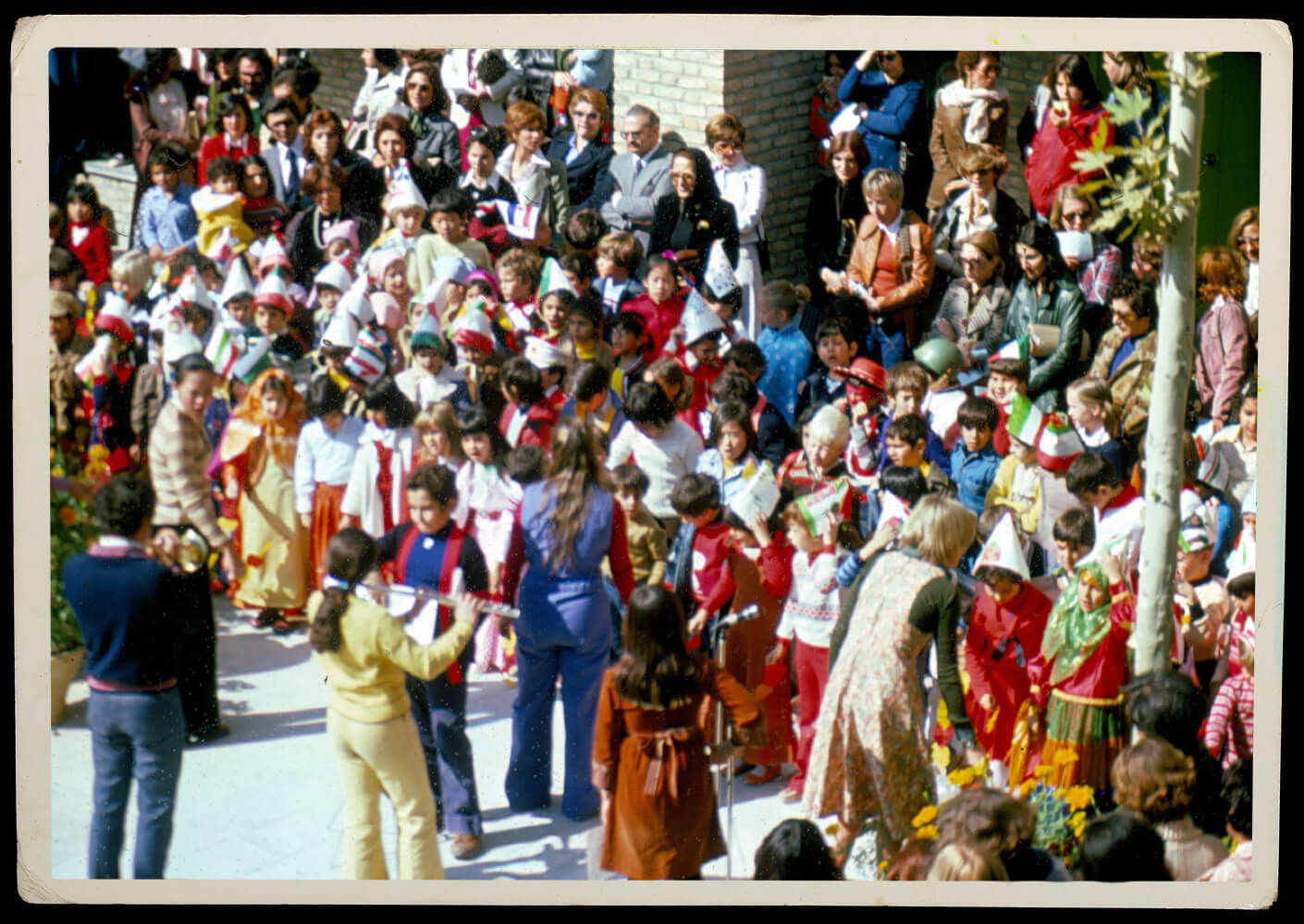 A group of students and teachers dressed in cultural garb.