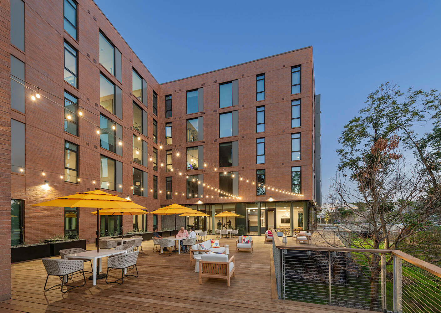 The project's outdoor deck, illuminated by string lights