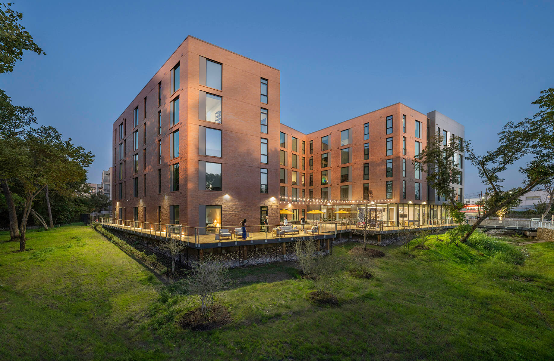 The C-shaped development wrapped around the back deck and surrounded by a sloping green