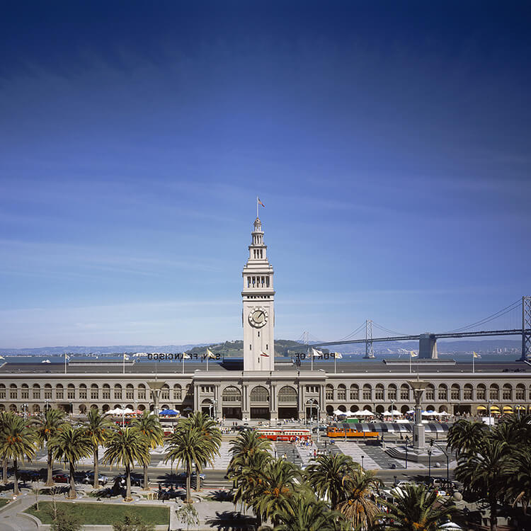 exterior of the ferry building with the bay bridge in the background