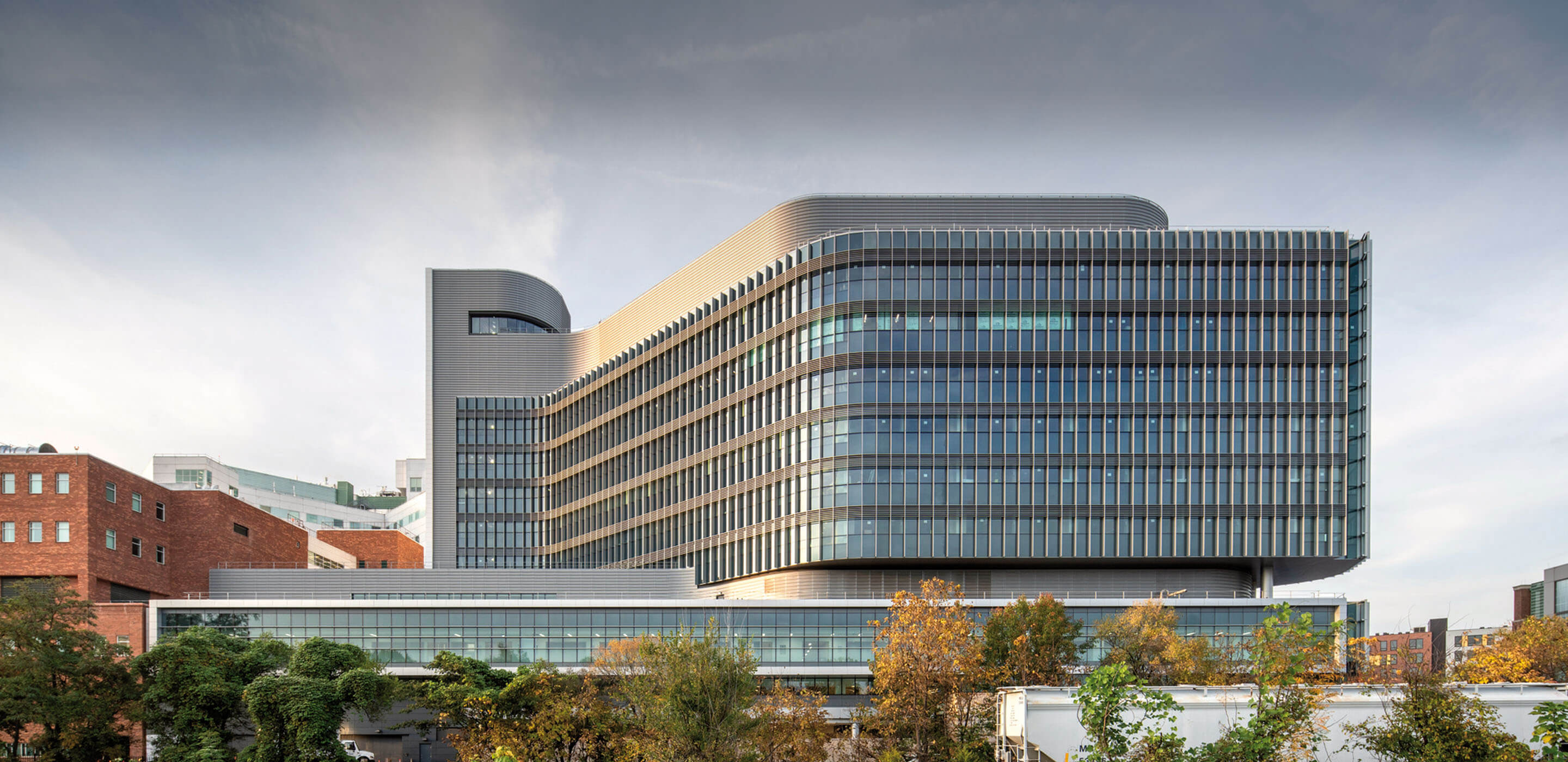 an exterior of a glass hospital building on a plinth