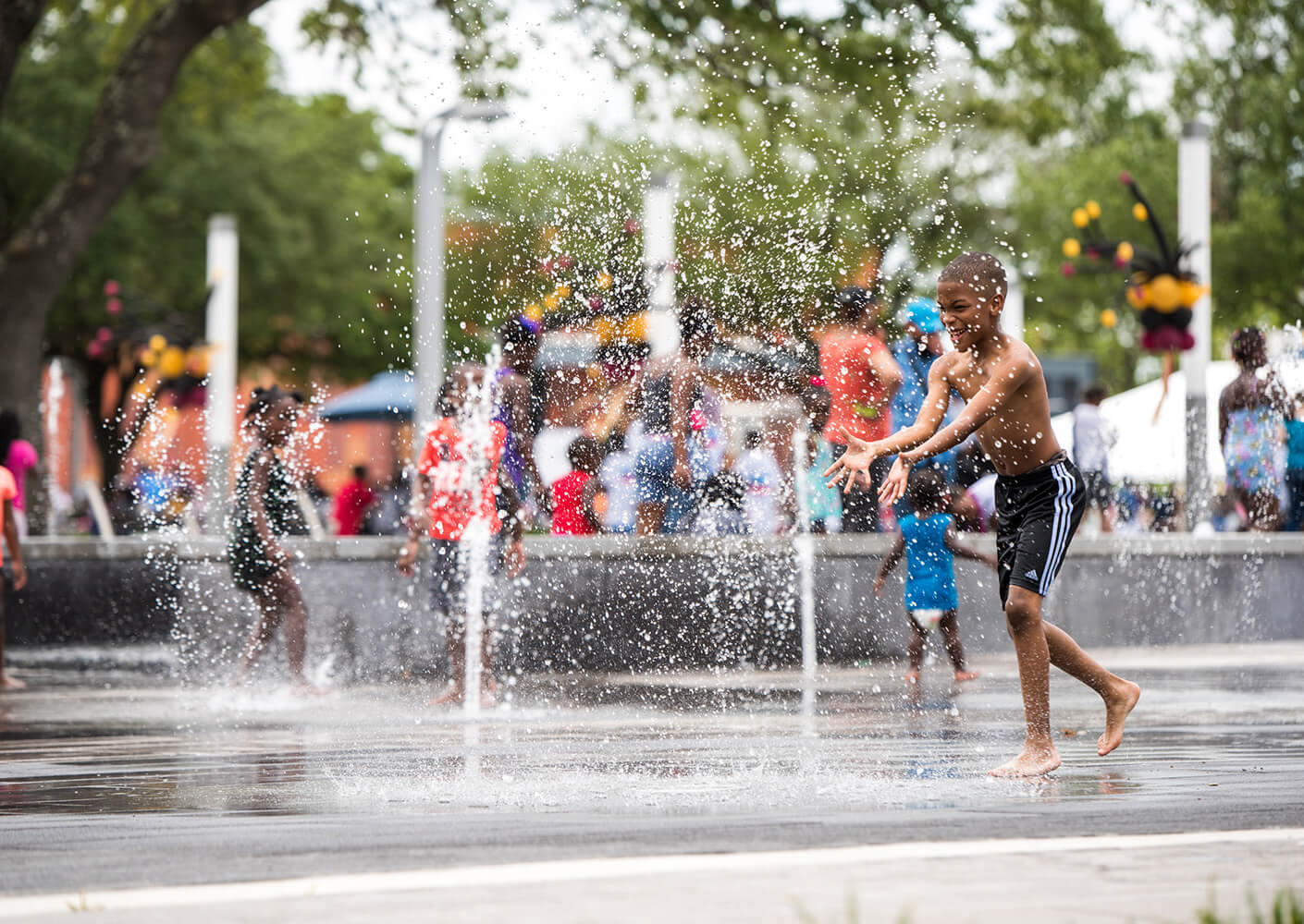 a child playing in a water feature