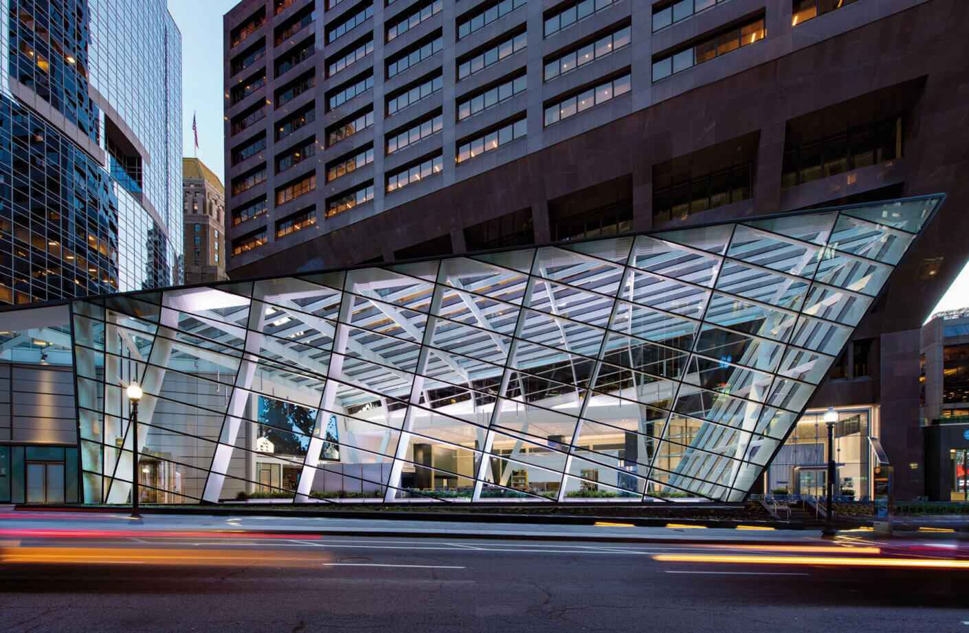 glass building next to cras driving at night