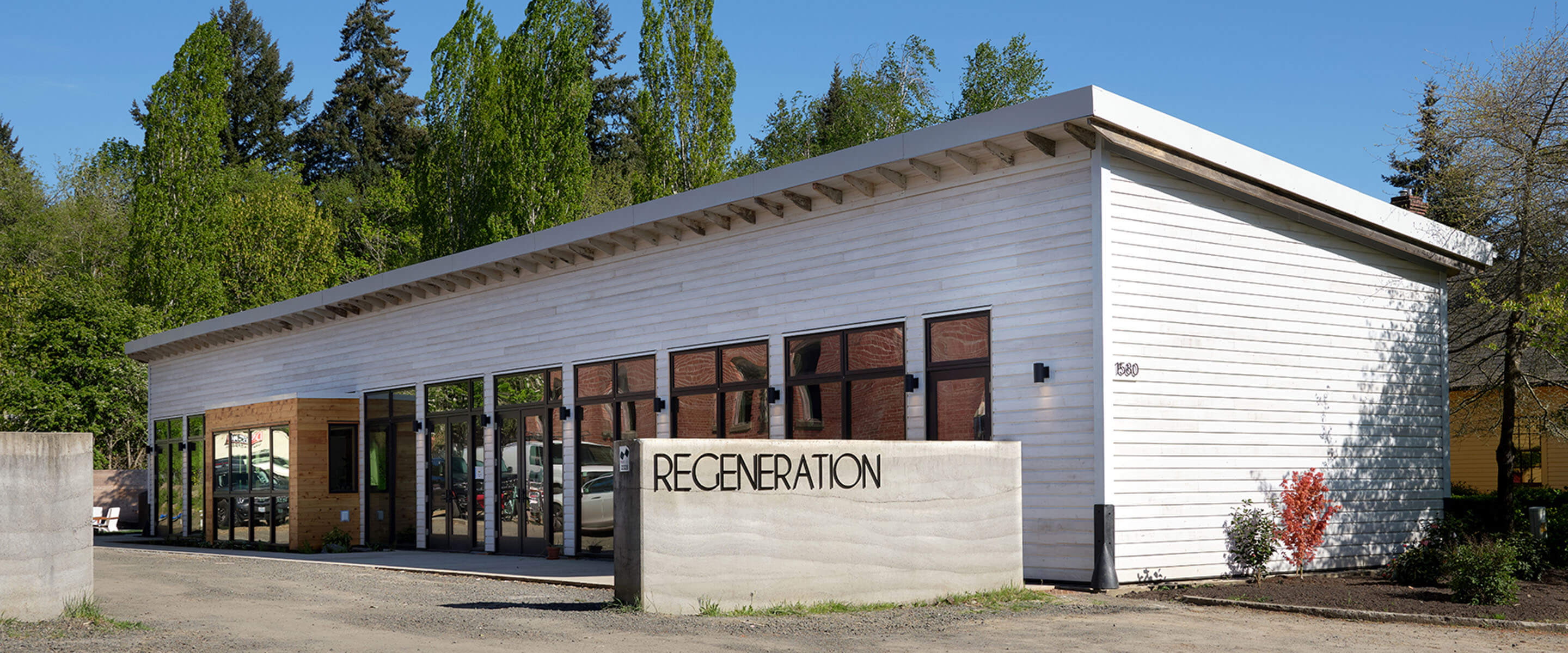 exterior of the studio, with a rammed earth signed that says 